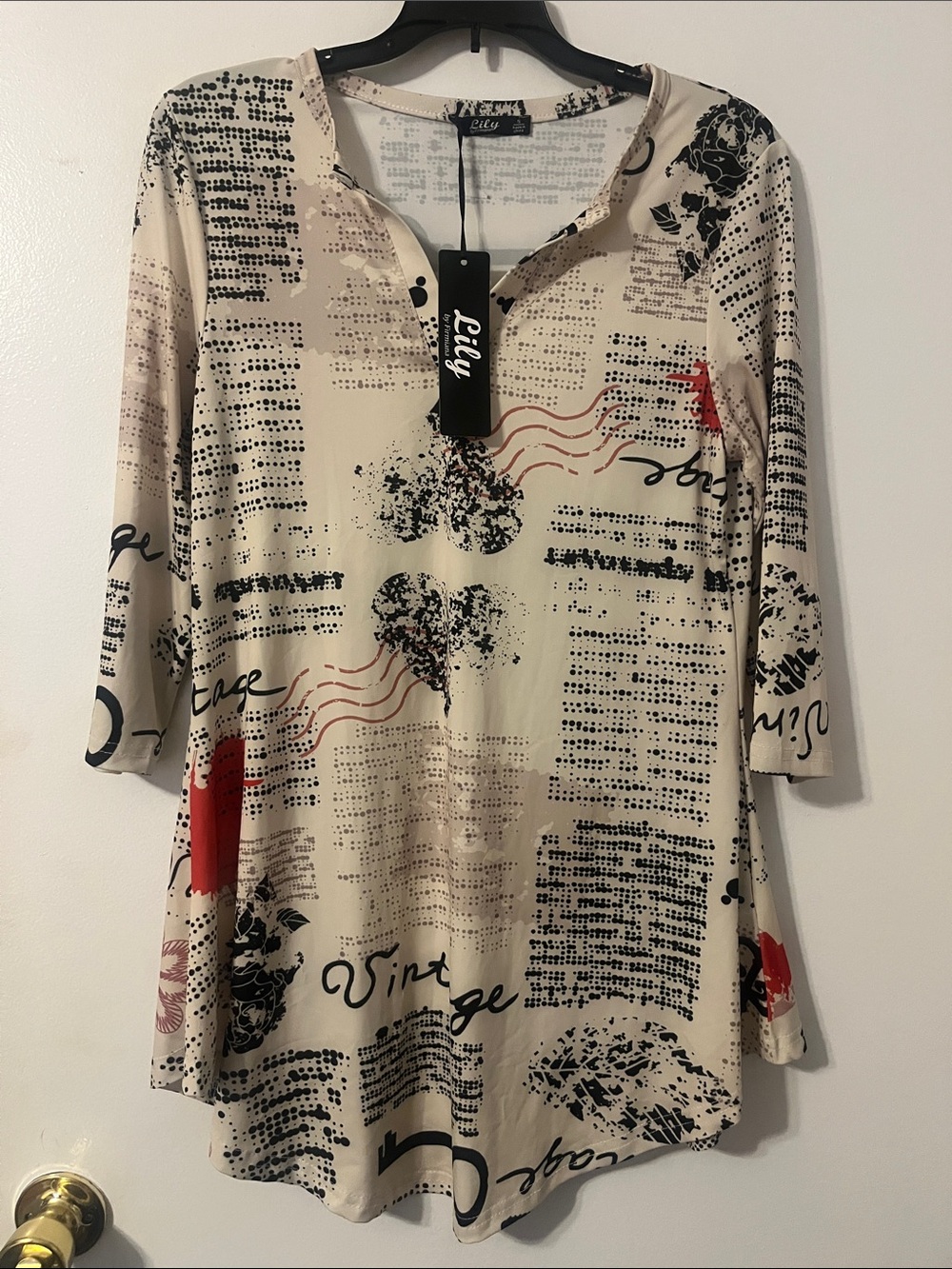 Lily S Beige Tunic with Black Script and Red News print trend Accents